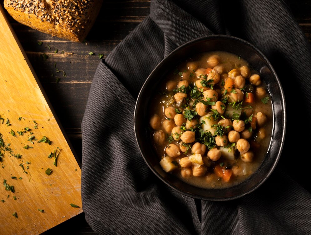 A bowl of chickpea soup garnished with fresh herbs